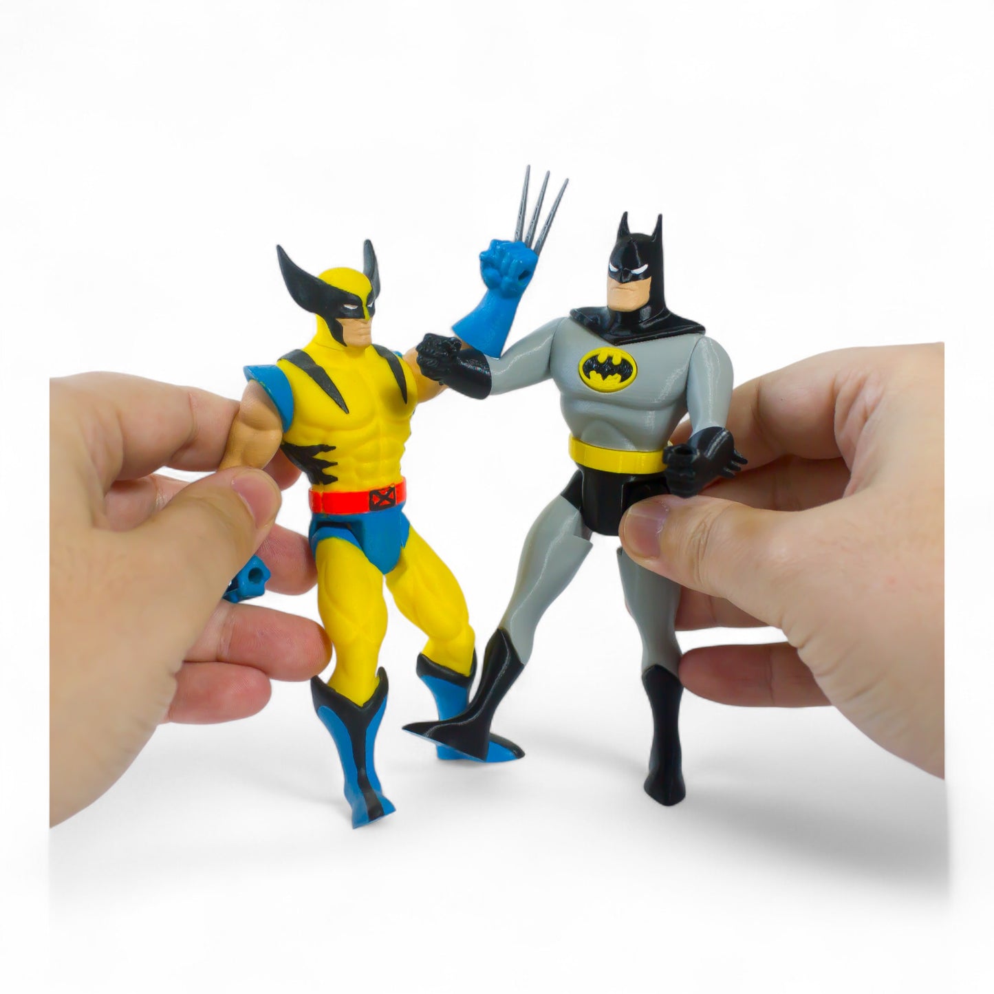 Batman-inspired action figure posed in hand-to-hand combat with another figure – shows scale and articulation